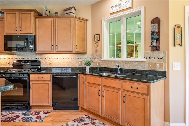 1100 Yorkshire Way, Victor, NY 14564 - kitchen with black appliances, dark stone counters, light wood-style floors, and decorative backsplash