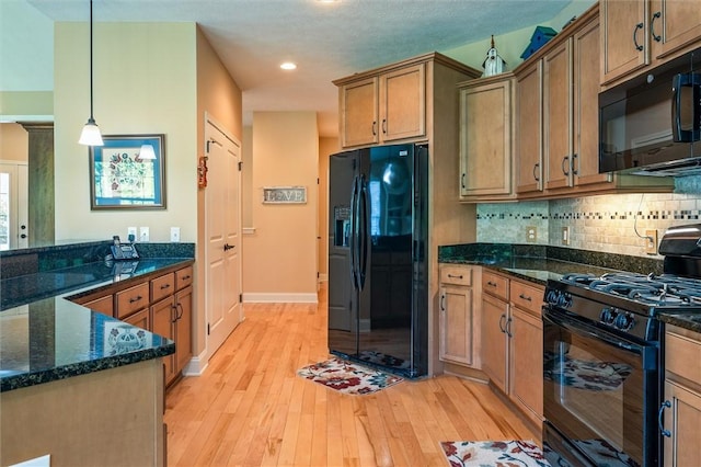 1100 Yorkshire Way, Victor, NY 14564 - kitchen with black appliances, light wood-style floors, hanging light fixtures, decorative backsplash, and dark stone counters