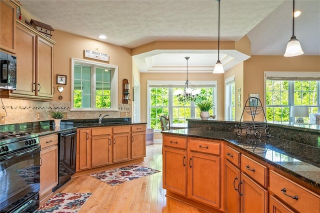1100 Yorkshire Way, Victor, NY 14564 - kitchen with black appliances, brown cabinets, light wood-type flooring, decorative backsplash, and a textured ceiling