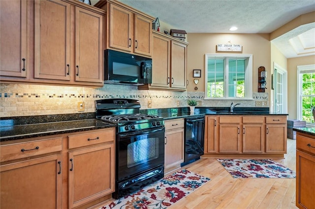 1100 Yorkshire Way, Victor, NY 14564 - kitchen featuring black appliances, light wood-style flooring, decorative backsplash, dark stone countertops, and brown cabinetry