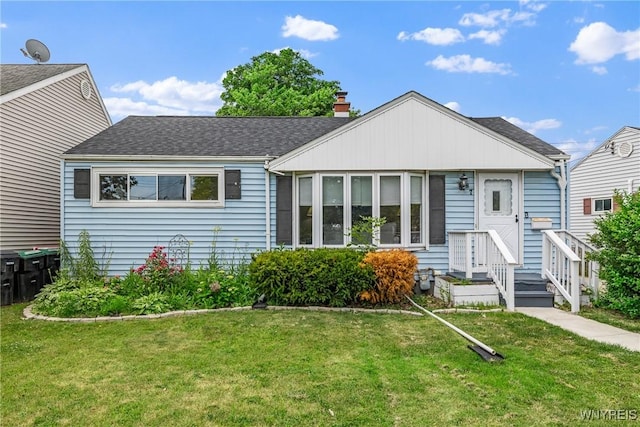 87 Ermann Dr, Tonawanda, NY 14217 - view of front of property with a front yard, a chimney, and a shingled roof