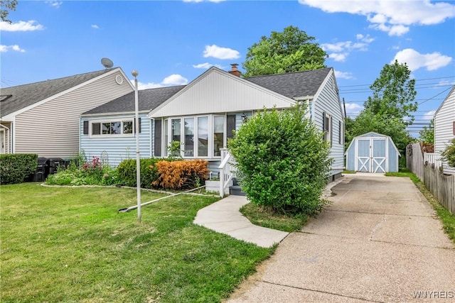 87 Ermann Dr, Tonawanda, NY 14217 - view of front of home with a shingled roof, a storage shed, and a chimney