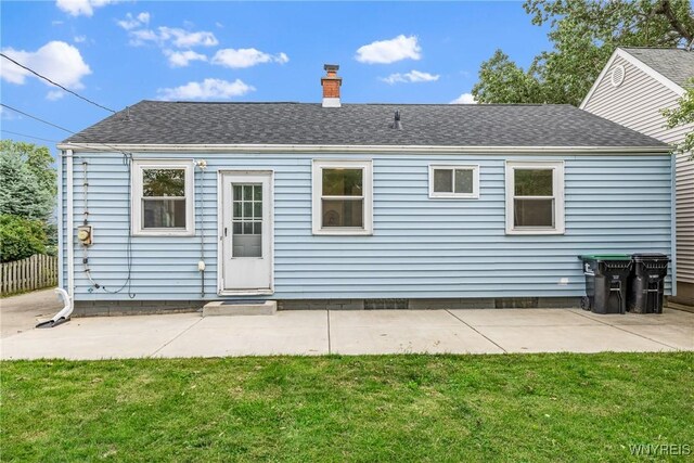 87 Ermann Dr, Tonawanda, NY 14217 - back of house featuring a chimney, a yard, a patio area, and roof with shingles