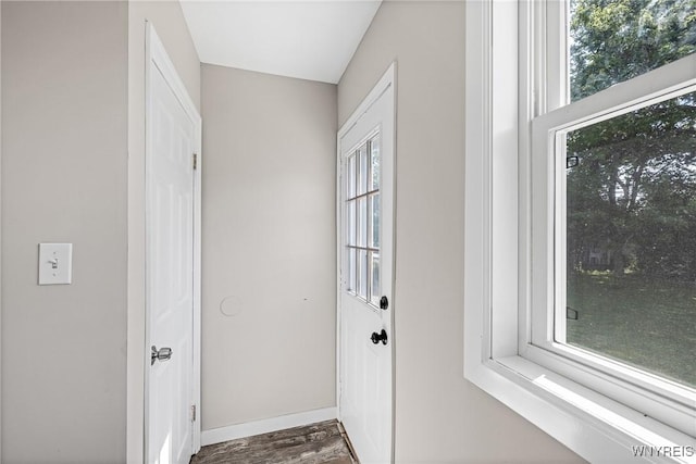 87 Ermann Dr, Tonawanda, NY 14217 - doorway to outside featuring baseboards and dark wood finished floors