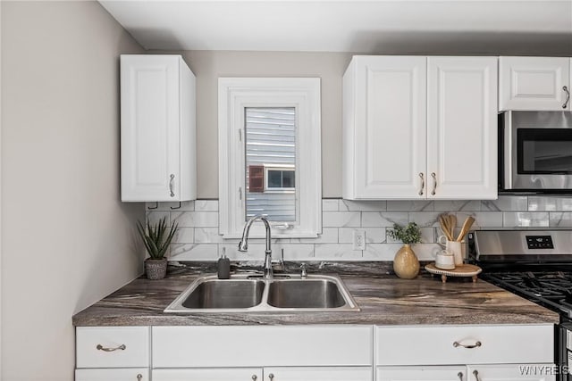 87 Ermann Dr, Tonawanda, NY 14217 - kitchen featuring stainless steel appliances, dark countertops, and white cabinets