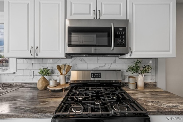 87 Ermann Dr, Tonawanda, NY 14217 - kitchen with appliances with stainless steel finishes, white cabinets, decorative backsplash, and dark countertops