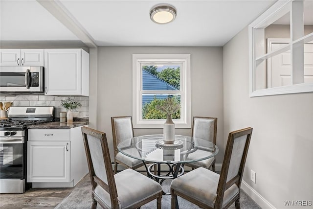 87 Ermann Dr, Tonawanda, NY 14217 - dining room featuring baseboards and wood finished floors