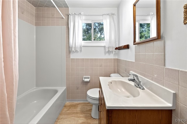 215 Rebecca St, Clay, NY 13212 - full bath featuring tile walls, healthy amount of natural light, vanity, shower / bath combination with curtain, and a wainscoted wall