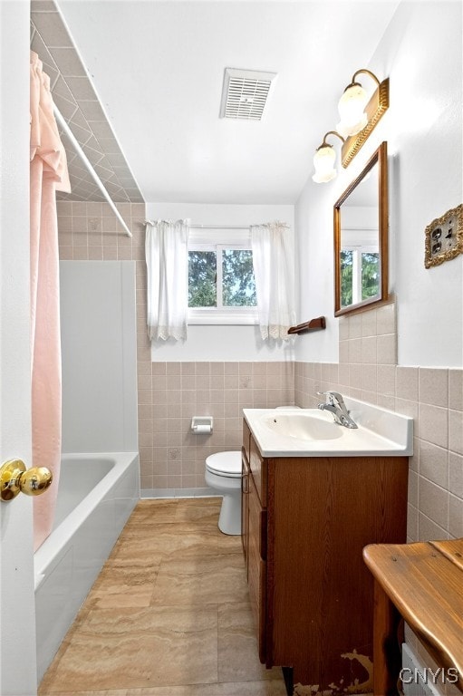 215 Rebecca St, Clay, NY 13212 - bathroom featuring tile walls, vanity, and shower / bathtub combination with curtain