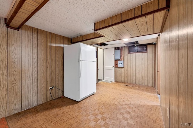 215 Rebecca St, Clay, NY 13212 - finished below grade area featuring freestanding refrigerator, wood walls, and a paneled ceiling