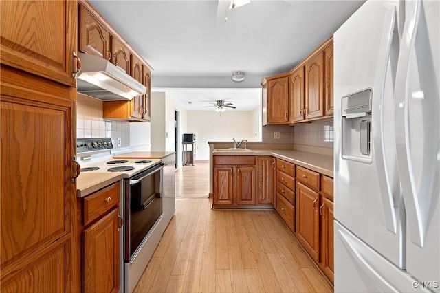 215 Rebecca St, Clay, NY 13212 - kitchen with white appliances, under cabinet range hood, ceiling fan, and tasteful backsplash
