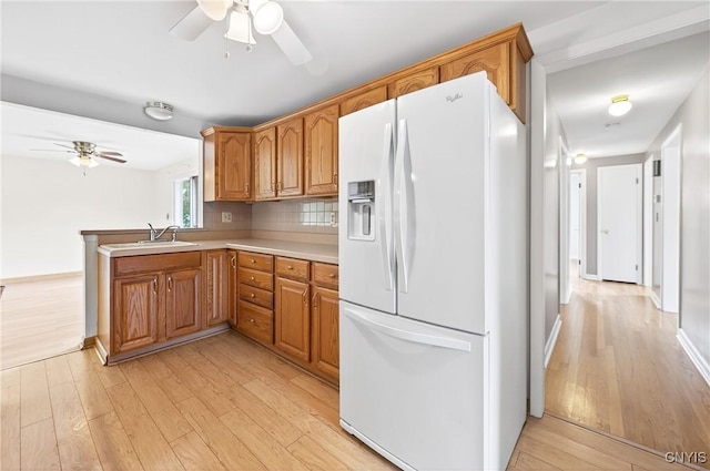 215 Rebecca St, Clay, NY 13212 - kitchen with white refrigerator with ice dispenser, ceiling fan, light wood finished floors, and brown cabinetry