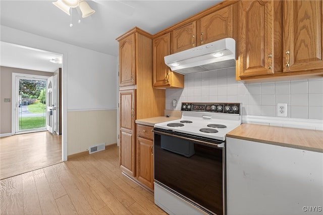 215 Rebecca St, Clay, NY 13212 - kitchen featuring white electric range, under cabinet range hood, light countertops, and light wood-style flooring
