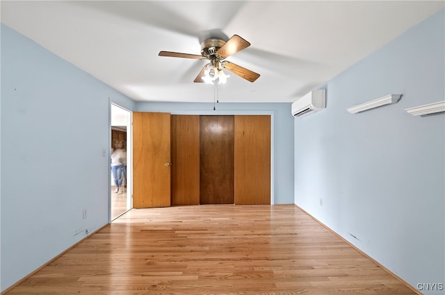 215 Rebecca St, Clay, NY 13212 - unfurnished bedroom featuring an AC wall unit, wood finished floors, and a ceiling fan
