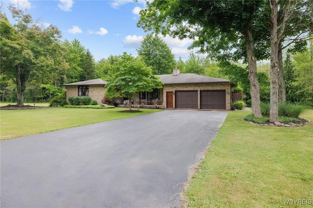 1575 Overhead Rd, Evans, NY 14047 - view of front of property with an attached garage, asphalt driveway, a front yard, and a chimney