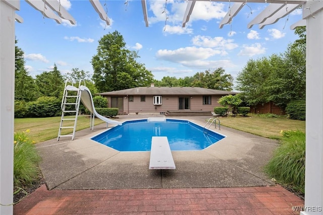 1575 Overhead Rd, Evans, NY 14047 - swimming pool featuring a diving board, a water slide, a lawn, and a patio area