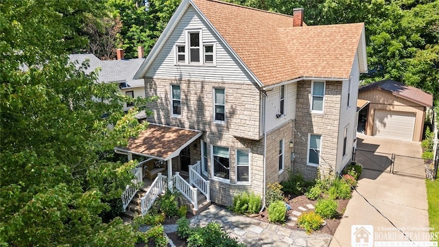 49 Day St, Pomfret, NY 14063 - view of front of property with stone siding, an outdoor structure, a gate, a chimney, and a detached garage