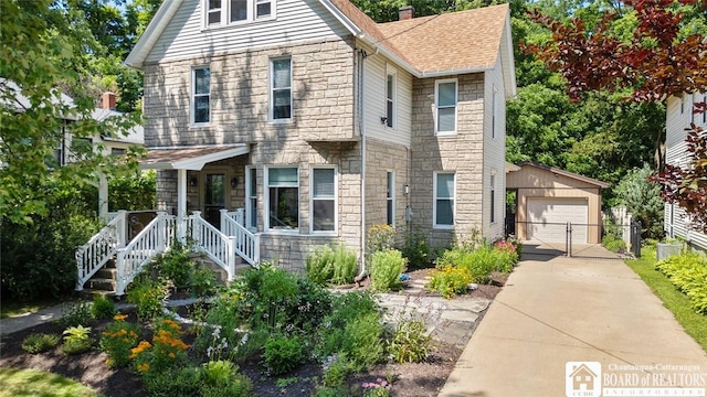 49 Day St, Pomfret, NY 14063 - view of front of house with stone siding, an outdoor structure, a detached garage, a gate, and a shingled roof