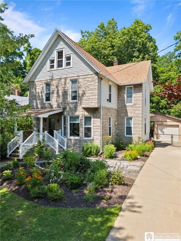 49 Day St, Pomfret, NY 14063 - view of front of property with stone siding, an outdoor structure, a detached garage, and a chimney