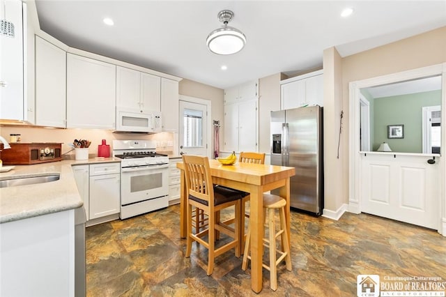 49 Day St, Pomfret, NY 14063 - kitchen with white appliances, stone finish floors, white cabinets, and recessed lighting