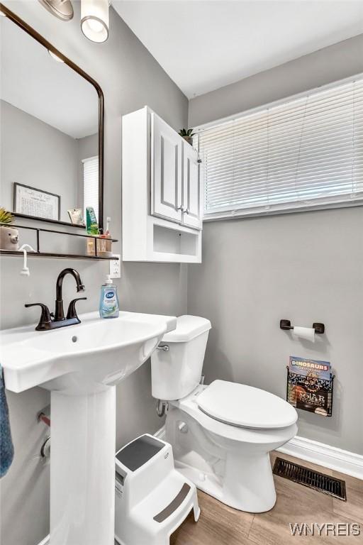 2051 Parker Blvd, Tonawanda, NY 14150 - bathroom featuring toilet and wood finished floors