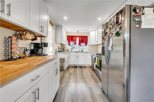 2051 Parker Blvd, Tonawanda, NY 14150 - kitchen featuring appliances with stainless steel finishes, white cabinetry, recessed lighting, and light wood-style flooring