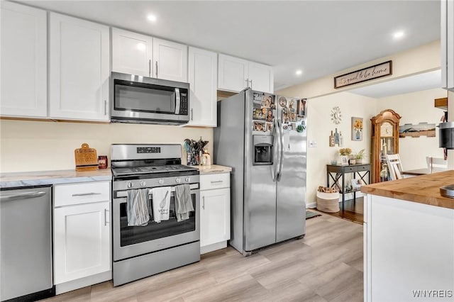 2051 Parker Blvd, Tonawanda, NY 14150 - kitchen featuring appliances with stainless steel finishes, white cabinetry, recessed lighting, and light wood-style floors
