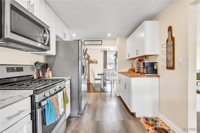 2051 Parker Blvd, Tonawanda, NY 14150 - kitchen with stainless steel appliances, wood finished floors, white cabinetry, butcher block countertops, and recessed lighting