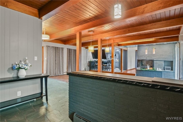 722 College Ter, Niagara Falls, NY 14305 - kitchen with a wooden ceiling with exposed beams, stone tile floors, a multi sided fireplace, and decorative light fixtures