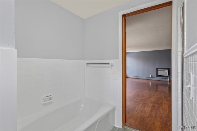 722 College Ter, Niagara Falls, NY 14305 - bathroom featuring a bath, baseboard heating, a wall unit AC, and a wainscoted wall