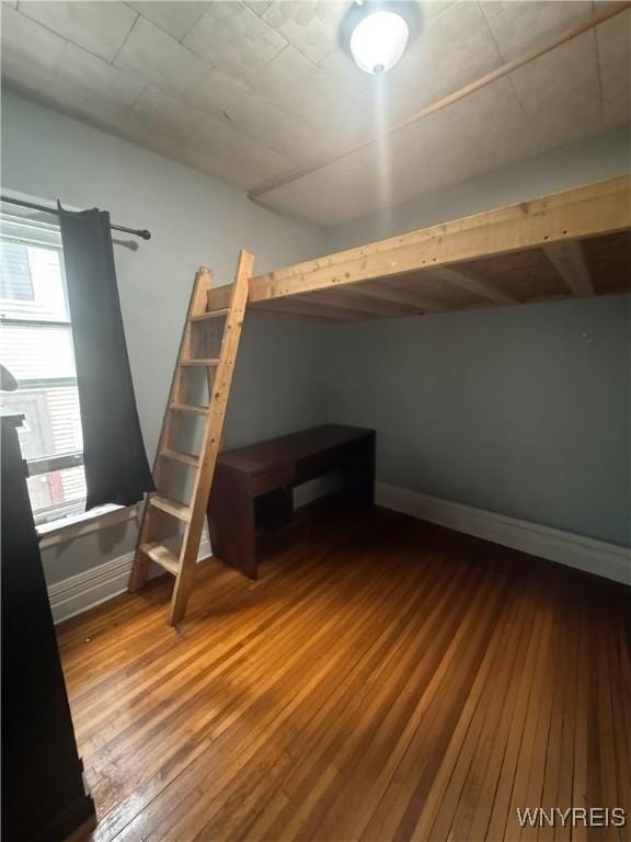 24 Northrup Pl, Buffalo, NY 14214 - unfurnished bedroom featuring wood-type flooring and baseboards