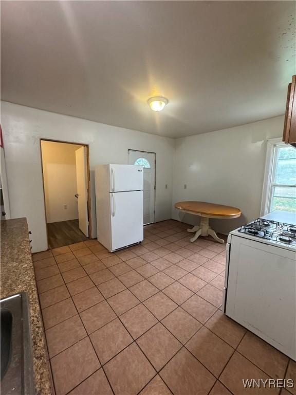 24 Northrup Pl, Buffalo, NY 14214 - kitchen with white appliances and light tile patterned floors