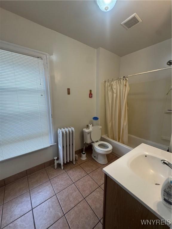 24 Northrup Pl, Buffalo, NY 14214 - full bathroom with radiator heating unit, shower / bathtub combination with curtain, tile patterned floors, and vanity