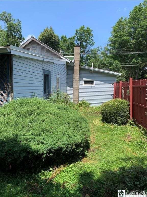 749-753 W Main, Ellington, NY 14732 - rear view of property featuring a chimney