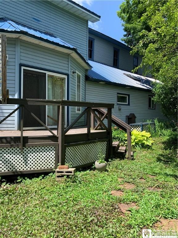 749-753 W Main, Ellington, NY 14732 - back of property with a wooden deck and a metal roof