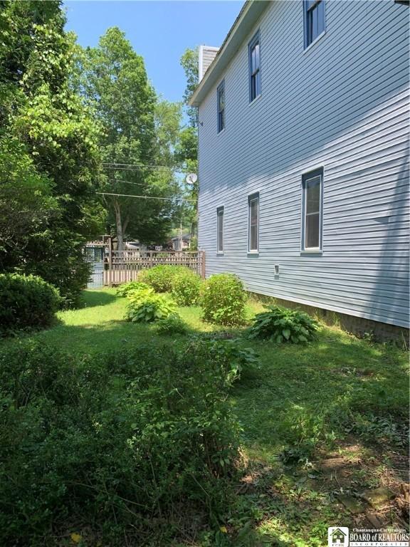 749-753 W Main, Ellington, NY 14732 - view of side of home featuring a chimney