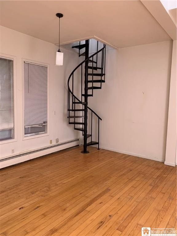 749-753 W Main, Ellington, NY 14732 - staircase featuring a baseboard heating unit and wood-type flooring