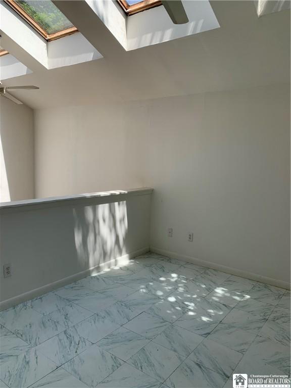 749-753 W Main, Ellington, NY 14732 - spare room with a skylight, ceiling fan, and marble look tiles