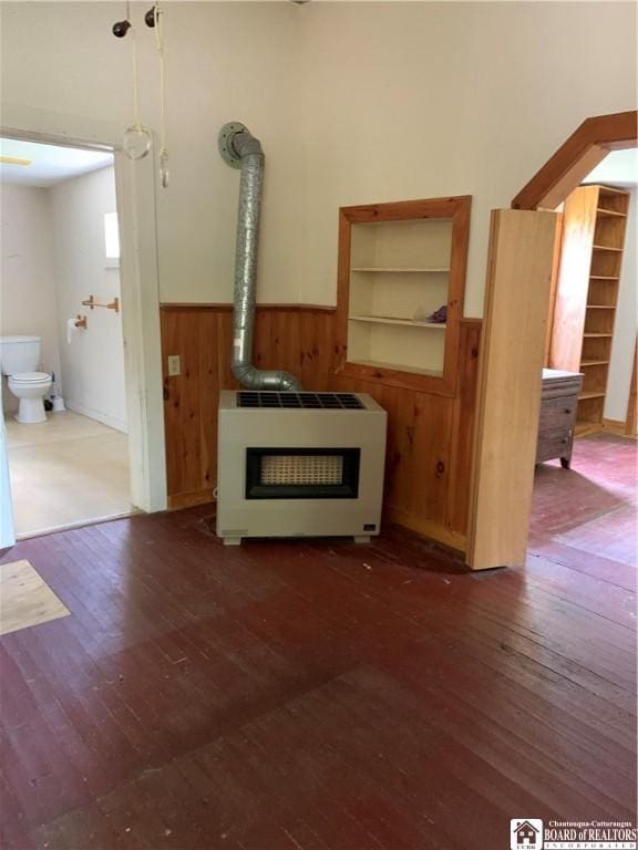 749-753 W Main, Ellington, NY 14732 - unfurnished living room with heating unit, wainscoting, wood-type flooring, and wood walls