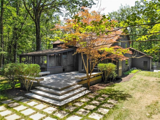 2657 Spencer Hill Rd, Corning, NY 14830 - back of property featuring a sunroom, a lawn, and a wooden deck