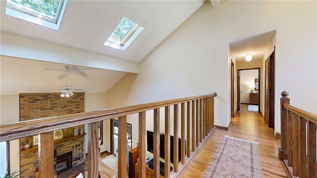 2657 Spencer Hill Rd, Corning, NY 14830 - corridor featuring a skylight, light wood-style floors, and an upstairs landing