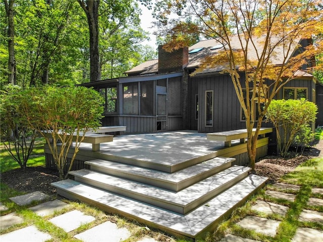 2657 Spencer Hill Rd, Corning, NY 14830 - back of house with a sunroom, a chimney, a wooden deck, and board and batten siding