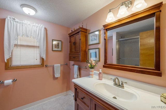 86 Hitching Post Ln, Amherst, NY 14228 - bathroom featuring vanity, a shower with shower door, tile patterned floors, and a textured ceiling
