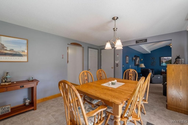 86 Hitching Post Ln, Amherst, NY 14228 - dining space featuring a chandelier, vaulted ceiling, and light tile patterned flooring