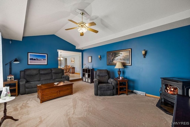86 Hitching Post Ln, Amherst, NY 14228 - carpeted living room with a wood stove, vaulted ceiling, a ceiling fan, and a textured ceiling