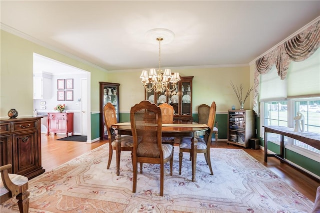 22 Red Leaf Dr, Chili, NY 14624 - dining area featuring a chandelier, light wood finished floors, and ornamental molding