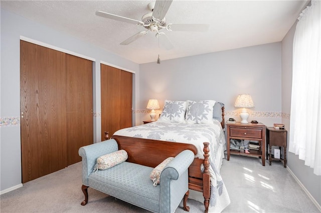 22 Red Leaf Dr, Chili, NY 14624 - bedroom with light colored carpet, multiple closets, and a ceiling fan