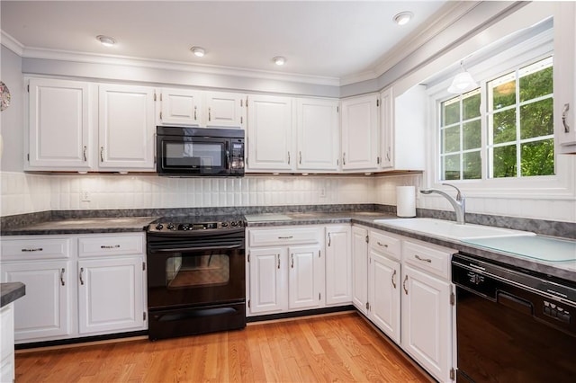 22 Red Leaf Dr, Chili, NY 14624 - kitchen featuring black appliances, dark countertops, white cabinetry, and crown molding