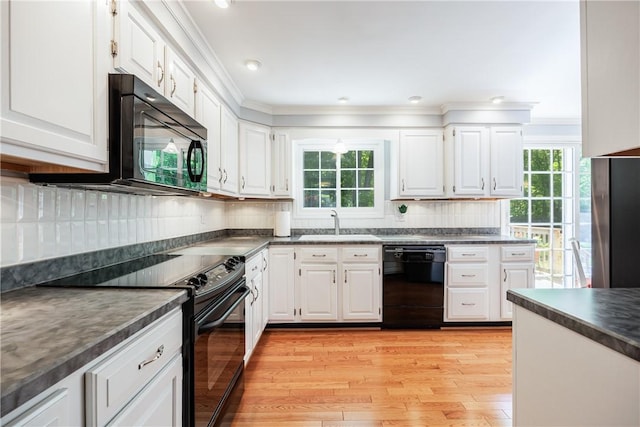 22 Red Leaf Dr, Chili, NY 14624 - kitchen featuring black appliances, dark countertops, light wood-style floors, white cabinets, and crown molding