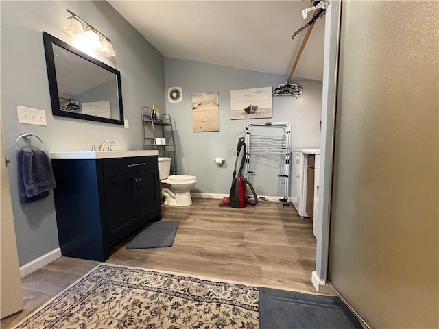 7 E St, Oneonta, NY 13820 - bathroom featuring lofted ceiling, vanity, and wood finished floors